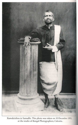 Sri Ramakrishna standing by pillar